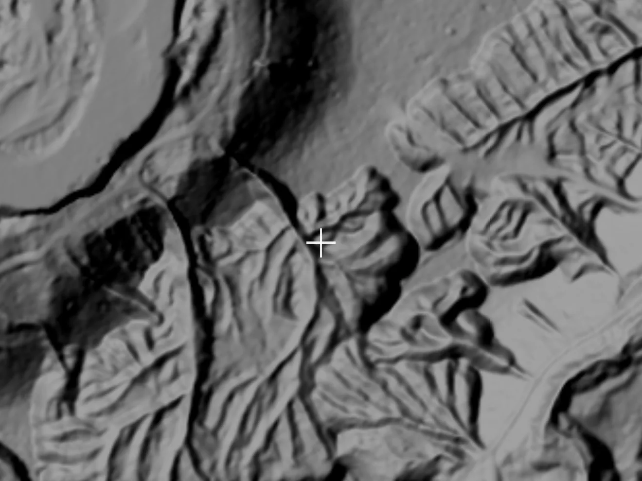 One meter LiDAR hillshade of the same ground, the canopy stripped away to show stacked placer benches, a hydraulic cut, ditch lines contouring across the slope, and feeder gullies running to the creek
